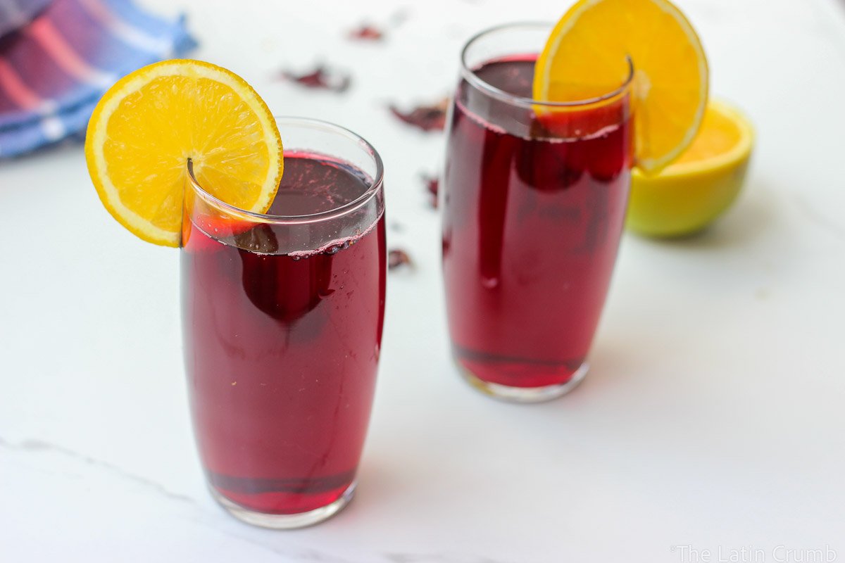 Floral, naturally deep red, and irresistibly refreshing. This agua de Jamaica recipe is made with dried hibiscus flowers, sugar, and warm spices. Classic and easy.