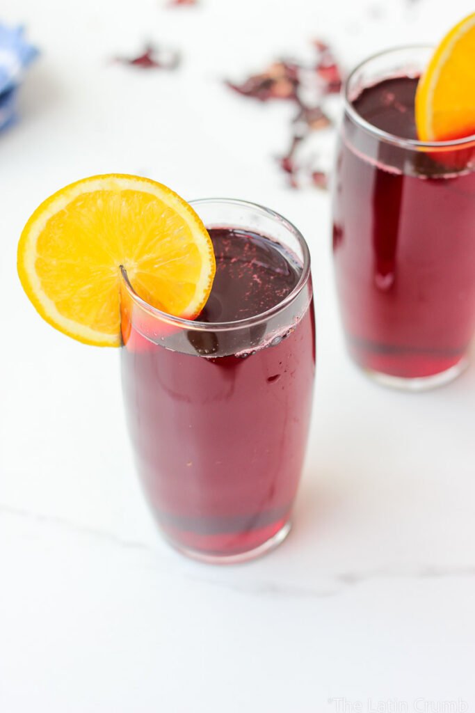 Floral, naturally deep red, and irresistibly refreshing. This agua de Jamaica recipe is made with dried hibiscus flowers, sugar, and warm spices. Classic and easy.